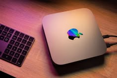 an apple computer sitting on top of a wooden desk next to a keyboard and mouse