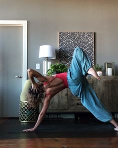 a woman is doing yoga in her living room