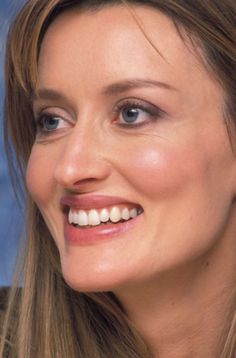 a close up of a woman smiling for the camera