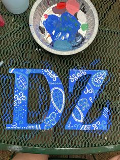 there is a plate that has the number twenty seven painted on it with blue paint