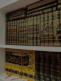 many books are on the shelves in a book store, with arabic and english writing