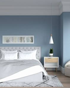 a bedroom with blue walls and white furniture