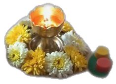 a small metal bowl with flowers around it and a candle in the center on a white background