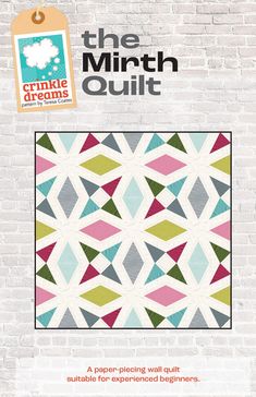 the cover of the quilt book, featuring an image of a white brick wall and colorful geometric