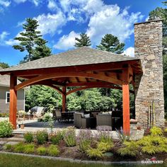 an outdoor covered patio with furniture and trees