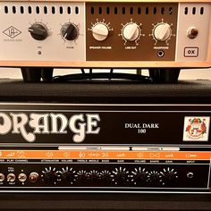 the orange dual dark amplifier sits on top of another amp