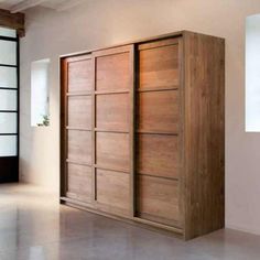 a large wooden cabinet sitting in the middle of a room