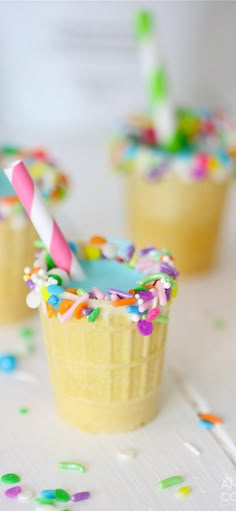 cupcakes with sprinkles and a straw sticking out of them