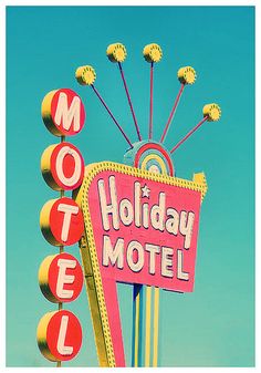 a motel sign with the word holiday hotel written on it