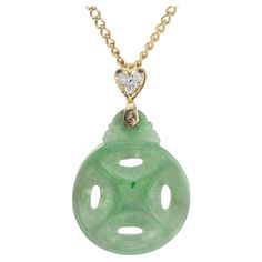 Jadeite Jade and diamond pendant. GIA certified Carved round natural color jade, no indications of impregnation, pendant with 3 round diamonds in a heart shaped 18k yellow gold frame. 16 inch 18k yellow gold chain. 1 round carved jadeite jade 22.06 x 17.52 x 3.41 mm GIA certificate# 5212652206 3 round cut diamonds, approx. total weight .05cts SI G 18k yellow gold Weight: 6.2 grams 16 inch chain Antique Diamond Rings Vintage, Antique Earrings Vintage, Antique Sapphire Rings, Diamond Rings Vintage, Vintage Antique Wedding, Vintage Antique Engagement Rings, Vintage Wedding Bands, Wedding Bands Vintage, Antique Wedding Bands