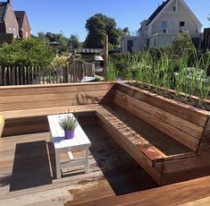 a wooden bench sitting on top of a wooden deck