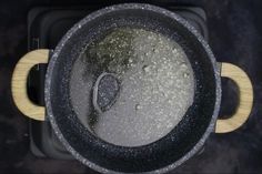 an aerial view of a pan with some food in it and the lid partially covered