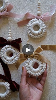 someone is holding up some crocheted ornaments to show off their crafting skills