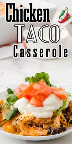 chicken taco casserole on a white plate with tomatoes and lettuce