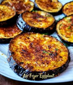 an eggplant dish on a white plate with parmesan cheese and herbs