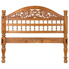 a wooden bed frame with intricate carvings on the headboard and foot board, isolated against a white background