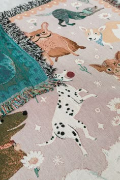 a blanket with animals on it is laying on the floor