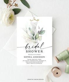 the bridal shower card is next to some white flowers and twine spools