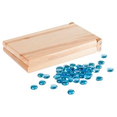 a wooden cutting board with blue glass pebbles