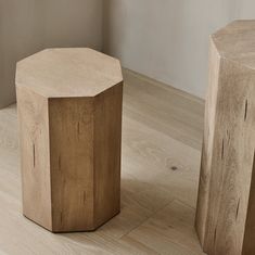 two wooden stools sitting on top of a hard wood floor next to each other