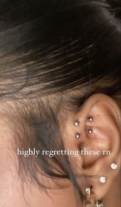 a woman with piercings on her ear and behind the ear is an earring