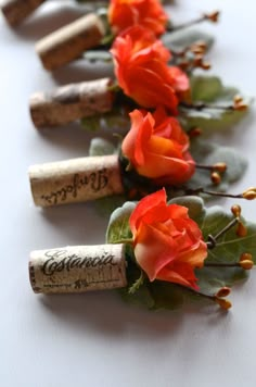 several wine corks with flowers and leaves on them are lined up in a row