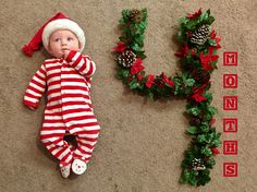 a baby is laying on the floor next to christmas wreaths and letters that spell it's 10