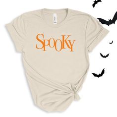 Spooky sweet "Spooky" graphic in your choice of orange or white. Perfect for this spooky season! Wear to Halloween parties, or just around town for halloween spirit! For ALL Spooky Adult Tees click here to view.For Spooky Adult Sweatshirts click here to view. Adult Sizes S-XXL (unisex sizing)Bella + Canvas4.2 oz. Airlume combed and ring-spun cottonPre-shrunkFor a more relaxed fit, size up! Sewing 101, Camp Style, Diy Halloween Projects, Sewing Workshop, Halloween Lights, Football Outfits, Halloween Spirit, Halloween Parties, Halloween T Shirt