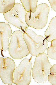 sliced apples and pears are arranged in a pattern on a white background, top view