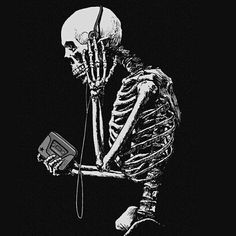 a skeleton holding a game controller in its hand and looking at it's screen