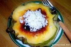 a plate with some food on it and a fork next to it, sitting on a wooden table