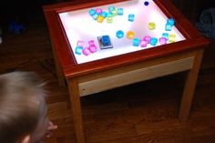 a young child playing with a game on a table