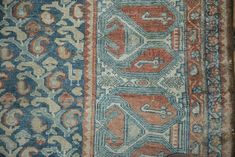 an old rug with many different colors and patterns on it's sides, including blue, red, orange, and white