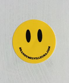 a yellow smiley face sticker with the words randomvilleieslagon written on it