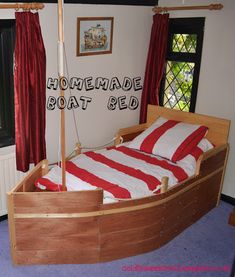 a bed with a red and white striped comforter in a room next to a window