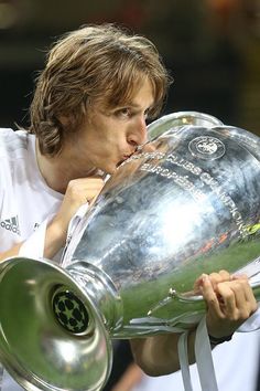 the man is kissing the trophy on his face