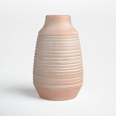 a white vase sitting on top of a table