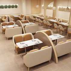 an empty restaurant with tables and chairs in the center, all set up for dinner