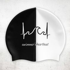 a black and white swim cap with the words swimming heart beat written in cursive writing