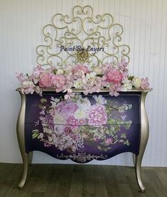 a dresser with flowers painted on it