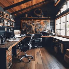 an office with wooden floors and black walls