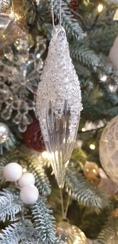 an ornament hanging from the top of a christmas tree