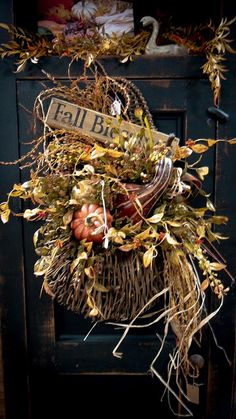 a door with a wreath on it that says fall