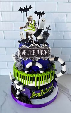 a three tiered cake decorated with halloween decorations