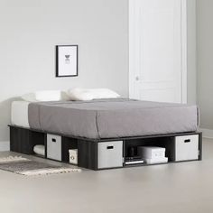 a bed with drawers underneath it in a room