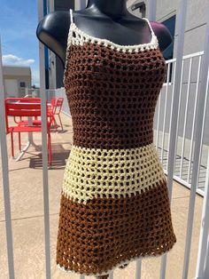 a crocheted dress is displayed on a mannequin