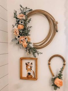 some flowers are hanging on the wall next to two pictures and a cow's head