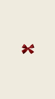 a red bow on top of a white wall