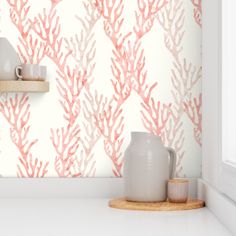 the wallpaper in this kitchen is painted with corals and white, as well as two vases