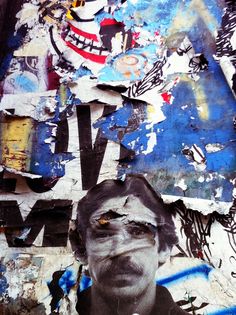 a man's face is covered with torn up paper and other pieces of art